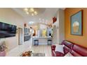 Spacious living area featuring tile floors, bar seating, and recessed lighting at 2506 Shelby Cir, Kissimmee, FL 34743