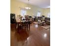 Open-concept living area with a dining set, comfortable seating, and ample space for relaxation at 319 N Scenic Hwy, Frostproof, FL 33843