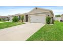 Charming single-story home with a well-manicured lawn and a two-car garage at 341 Alexzander Way, Winter Haven, FL 33881