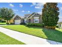 Well-maintained single-story home with stone accents, lush landscaping, and manicured lawn at 4133 Foxhound Dr, Clermont, FL 34711
