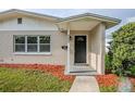 The home's front entrance, accentuated by stylish door, house number, and meticulous landscaping at 4200 Colony Way, Orlando, FL 32808