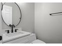 Modern half bathroom featuring a sleek vanity, contemporary fixtures, and fresh design at 461 Black Knight Way, Longwood, FL 32779