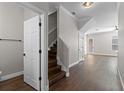 Inviting foyer with hardwood floors, leading to the living area and staircase at 461 Black Knight Way, Longwood, FL 32779