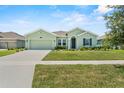 Attractive one-story home with well-maintained lawn, a two-car garage, and inviting curb appeal at 5220 Red Coral Cir, Mount Dora, FL 32757