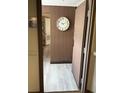 Condo entryway featuring a large wall clock, modern decor and light wood flooring offering a unique welcome at 6165 Carrier Dr # 1801, Orlando, FL 32819