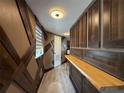 Unique hallway boasting decorative wood paneling and a built-in serving bar at 6165 Carrier Dr # 1801, Orlando, FL 32819