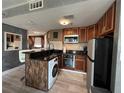 Well-equipped kitchen featuring dark countertops and modern appliances at 6165 Carrier Dr # 1801, Orlando, FL 32819