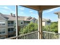 Enjoy picturesque views from this screened balcony overlooking lush trees and neighborhood buildings at 6451 Old Park Ln # 407, Orlando, FL 32835