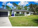 Well-manicured front lawn enhances the curb appeal of this cozy, light colored home at 655 N Arnold Ave, Groveland, FL 34736