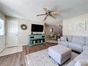 Cozy living room featuring a large sectional sofa, stylish decor, and an open layout to the dining area at 7375 Lake Dr, Sanford, FL 32771
