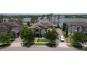 Beautiful, two-story home with stone accents, manicured lawn, and paved driveway at 7550 John Hancock Dr, Winter Garden, FL 34787
