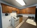 Functional kitchen with oak cabinets and countertop space, equipped with an electric range at 795 Temple Ave, Orange City, FL 32763