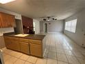 Spacious living room with tile flooring, seamlessly connected to the kitchen at 795 Temple Ave, Orange City, FL 32763