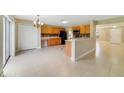 Spacious kitchen with oak cabinetry, tile flooring, and modern appliances, seamlessly connects to the dining area at 806 Sterling Spring Rd, Orlando, FL 32828