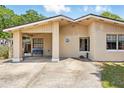 Attractive single-story house showcasing a covered parking area and tidy front yard at 1111 Liberty Ave, Mount Dora, FL 32757