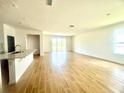 Bright and open-concept living room with tile flooring and sliding glass doors at 131 Addle Hill Ct, Deland, FL 32720