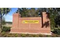 Welcoming brick sign for Fountain View of Ormond Beach, surrounded by lush landscaping and clear blue skies at 1359 Morning Walk Dr, Ormond Beach, FL 32174