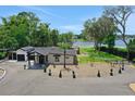 Beautiful exterior showcasing the landscaping, circular driveway and the home's modern design near the lake at 1700 Lake Markham Rd, Sanford, FL 32771