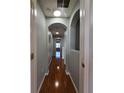 Hallway with arched openings and hardwood floors at 1754 Fritwell Ct, Ocoee, FL 34761