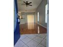 Bright living room featuring hardwood floors and sliding door access to backyard at 1754 Fritwell Ct, Ocoee, FL 34761