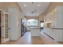 Beautiful kitchen with stainless steel appliances, an island, and bright white custom cabinets at 1947 Broadleaf Ct, Windermere, FL 34786