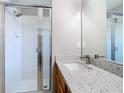 Bathroom featuring a sleek glass-enclosed shower, a modern vanity with light countertops, and contemporary fixtures at 2124 Fish Eagle St, Clermont, FL 34714