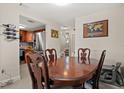 Dining room featuring a wooden table and chairs, tile floors, and kitchen access at 214 Majors Ln # C, Kissimmee, FL 34743