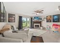 Cozy living room featuring a fireplace, tile flooring, and sliding glass doors to the patio at 214 Majors Ln # C, Kissimmee, FL 34743