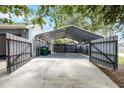 Spacious covered carport area with gated fence at 2420 Kerridale St, Deltona, FL 32738