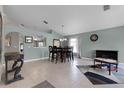 Open-concept dining area with tile floors, neutral wall paint, and stylish furniture at 2729 Stanwood Dr, Kissimmee, FL 34743