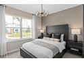 Modern bedroom with a large window, stylish lighting, and contemporary furnishings at 3367 Vine Leaf St, Apopka, FL 32712