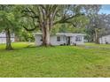 Lovely single-story home featuring a lush front lawn and a large tree with a swing at 405 Willow Ave, Sanford, FL 32771