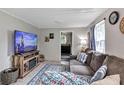 Comfortable living room with a large television, cozy sofa, and view into the kitchen at 405 Willow Ave, Sanford, FL 32771