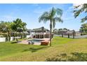 Expansive backyard with a fenced perimeter, pool, hot tub, and lush green grass at 4065 Shadowind Way, Gotha, FL 34734
