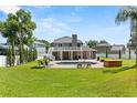 Grassy backyard featuring a pool, hot tub, outdoor seating, and a second story balcony at 4065 Shadowind Way, Gotha, FL 34734