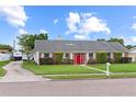 Inviting brick home featuring a manicured lawn and a long driveway at 407 Westchester Dr, Altamonte Springs, FL 32701