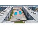 Aerial view showcasing community pools, beach access, and surrounding condo buildings at 4153 S Atlantic Ave # 2120, New Smyrna Beach, FL 32169