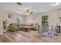 Bright living room features hardwood floors, cozy couches, and lots of natural light at 500 W Oakland Ave, Oakland, FL 34760