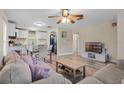 Open-concept living area with modern furniture, wood floors, and access to kitchen and laundry at 500 W Oakland Ave, Oakland, FL 34760