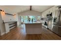 Stylish kitchen with modern appliances, including a large island with views of the lake at 6428 Lynn Rd, Orlando, FL 32810