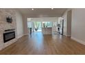 Open-concept living space with island, fireplace, and abundant natural light offers relaxation and comfort at 6428 Lynn Rd, Orlando, FL 32810