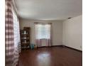 Bright living room with hardwood floors, window, and a classic built-in display cabinet at 6616 Blanche Ct, Orlando, FL 32818
