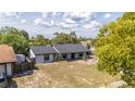 Aerial view of charming single-story home, lush yard and mature trees at 765 Coachlight Dr, Casselberry, FL 32730