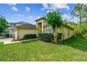 Attractive single-story home with a green lawn, shrubbery, and a side-entry two-car garage at 848 Magnolia Creek Cir, Orlando, FL 32828