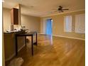 Open living room featuring hardwood floors, bright windows, and a sliding door to the backyard at 8608 Falstaff Pl, Oviedo, FL 32765