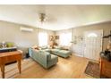 Inviting living room featuring a large sofa, ceiling fan, and ample natural light at 920 Timor Ave, Orlando, FL 32804
