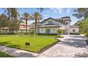 Expansive front yard and landscaping surround this home with a paved driveway leading up to a pristine residence at 9259 Tibet Pointe Cir, Windermere, FL 34786