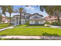 Beautiful exterior showcasing a well-manicured lawn, elegant landscaping, and the home's architectural design at 9259 Tibet Pointe Cir, Windermere, FL 34786