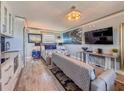 Stylish condo with a living room and kitchen combo, complemented by modern beach-themed artwork at 935 S Atlantic Ave # 244, Daytona Beach, FL 32118