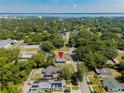 Aerial view of the home in a neighborhood near the water with mature trees at 1002 S Locust Ave, Sanford, FL 32771